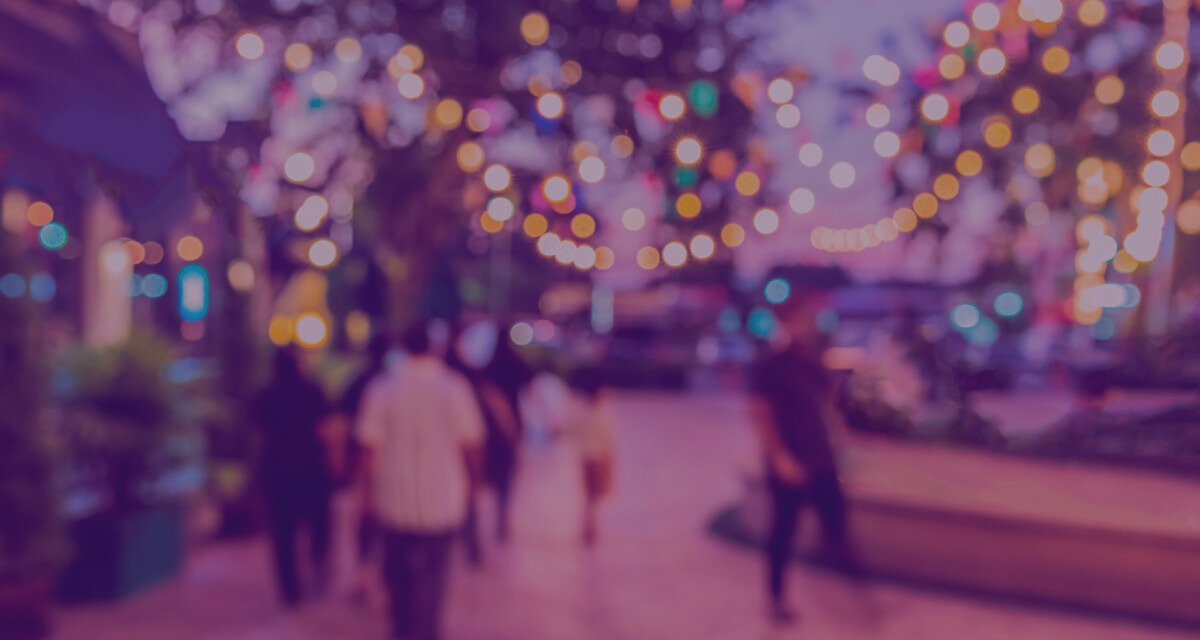 Blurred image of street full of lights and people walking